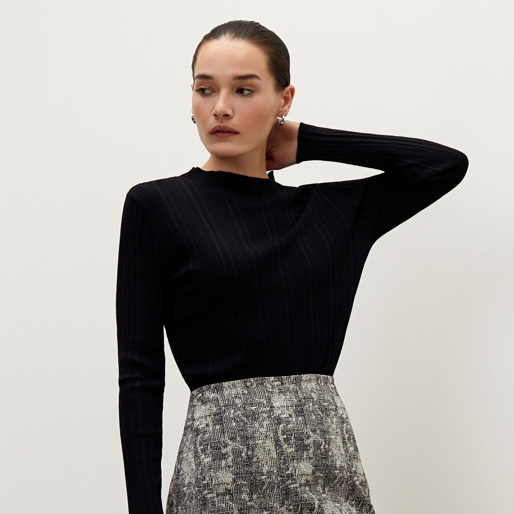 Front image of a woman standing wearing the Noho skirt in crackle | Exclude
