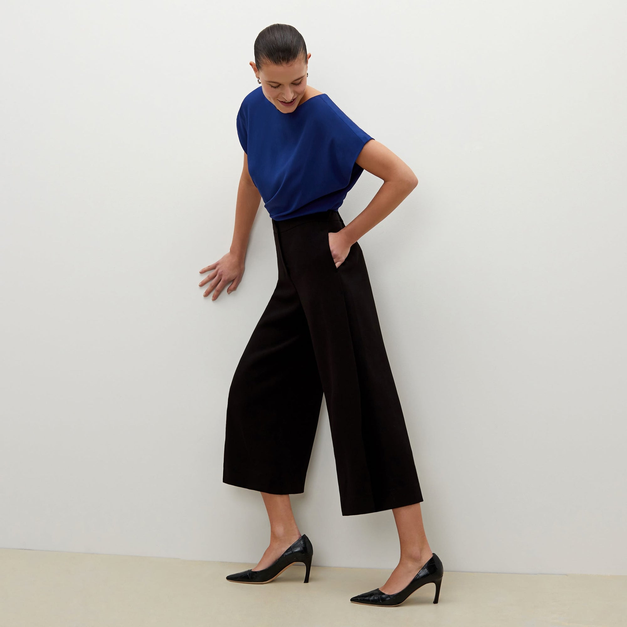 Front image of a woman standing wearing the Zhou culotte in black | Exclude