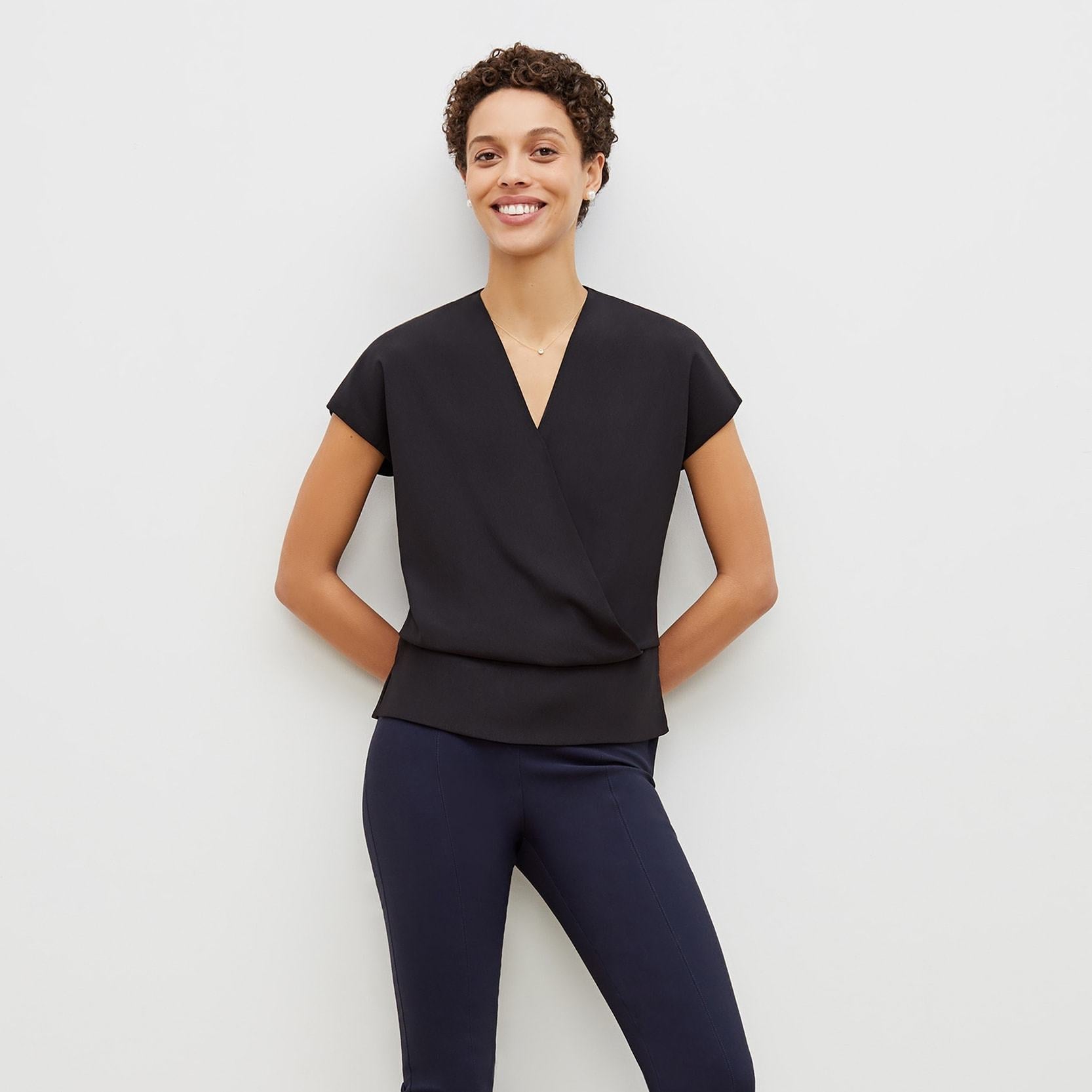 Front image of a woman standing wearing the foster pant in dark navy | Exclude