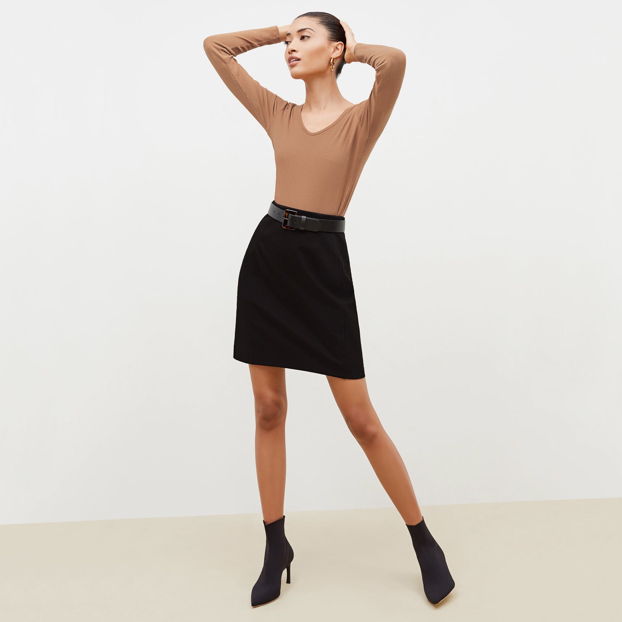 Front image of a woman standing wearing the marcia in camel | Exclude