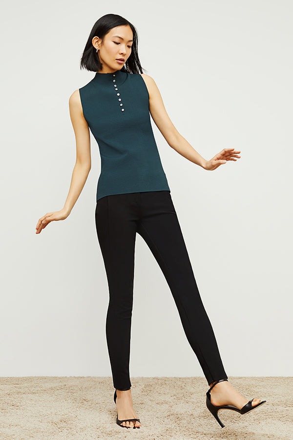 Front image of a woman standing wearing the curie pant in black | Exclude