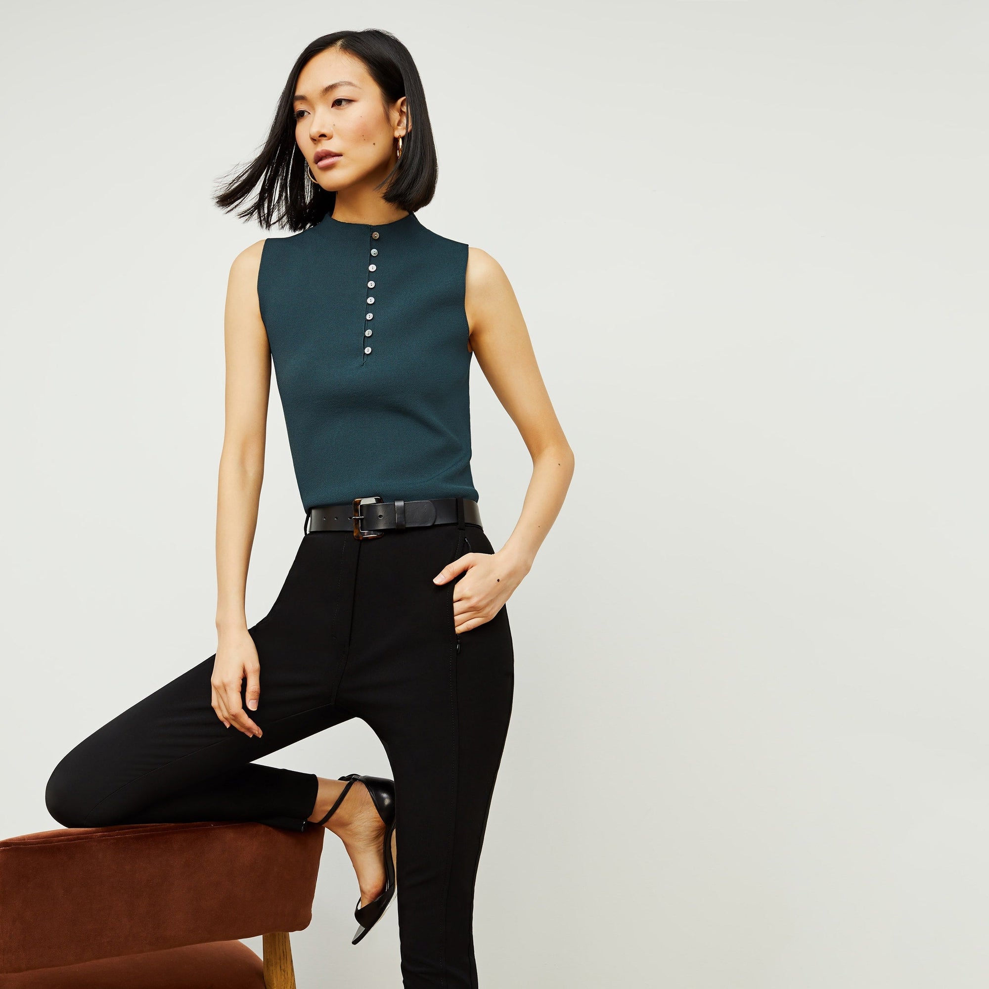 Front image of a woman standing wearing the curie pant in black