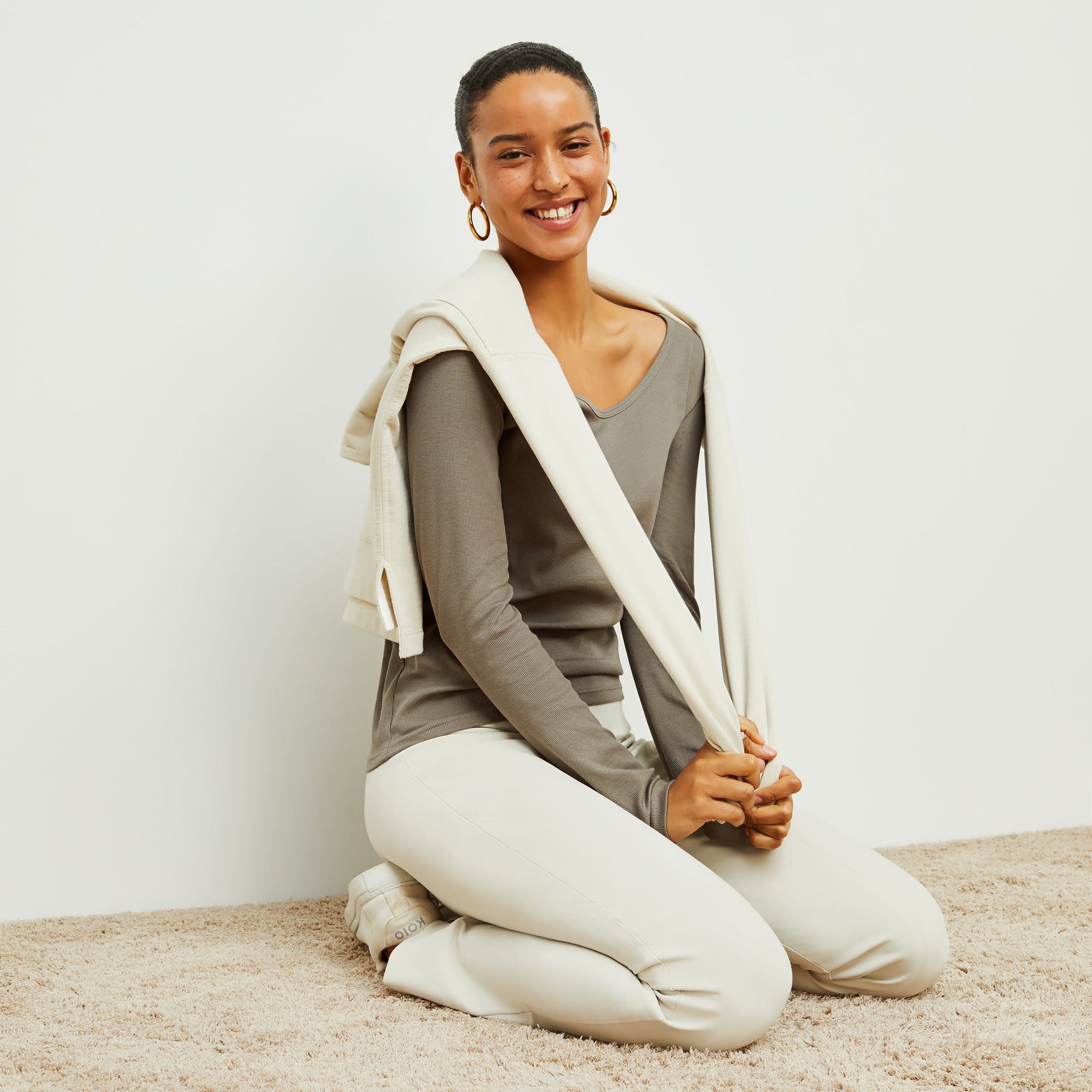 Front image of a woman standing wearing the foster pant in bone | Exclude