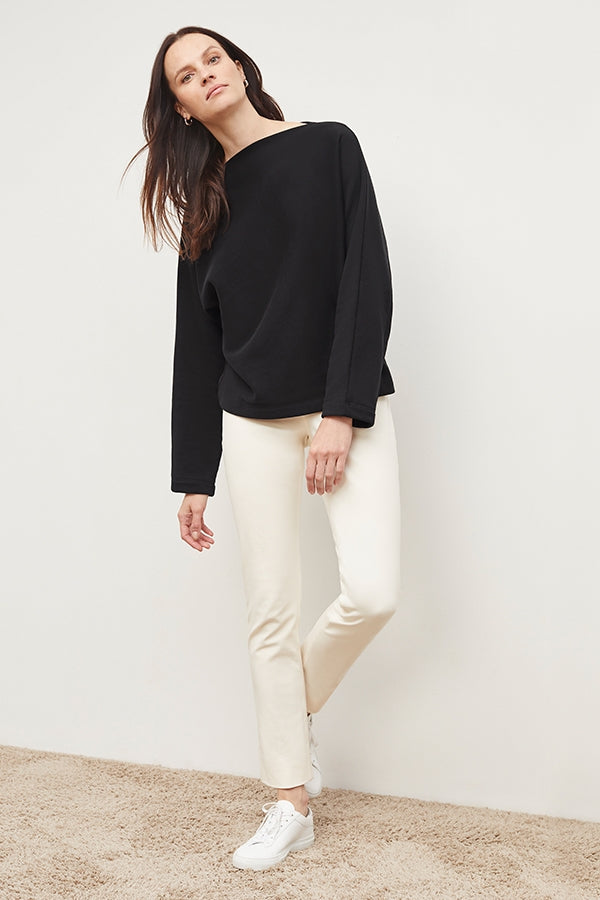Front image of a woman standing wearing the foster pant in bone | Exclude