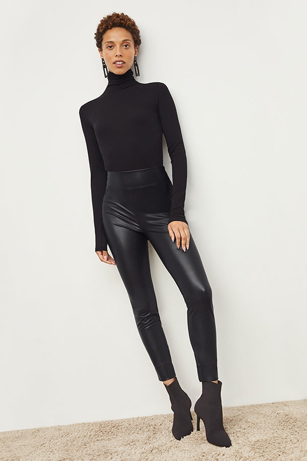 Front image of a woman standing wearing the Harrington Leather—Vegan Leather in Black | Grid | Exclude