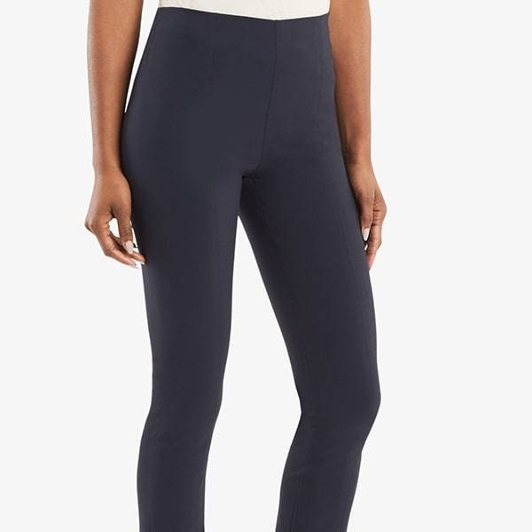 Alt grid image of a woman standing wearing the Foster pant in dark navy. | Exclude