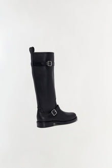 Black leather tall boot with buckle straps and flat sole, shown in profile view.