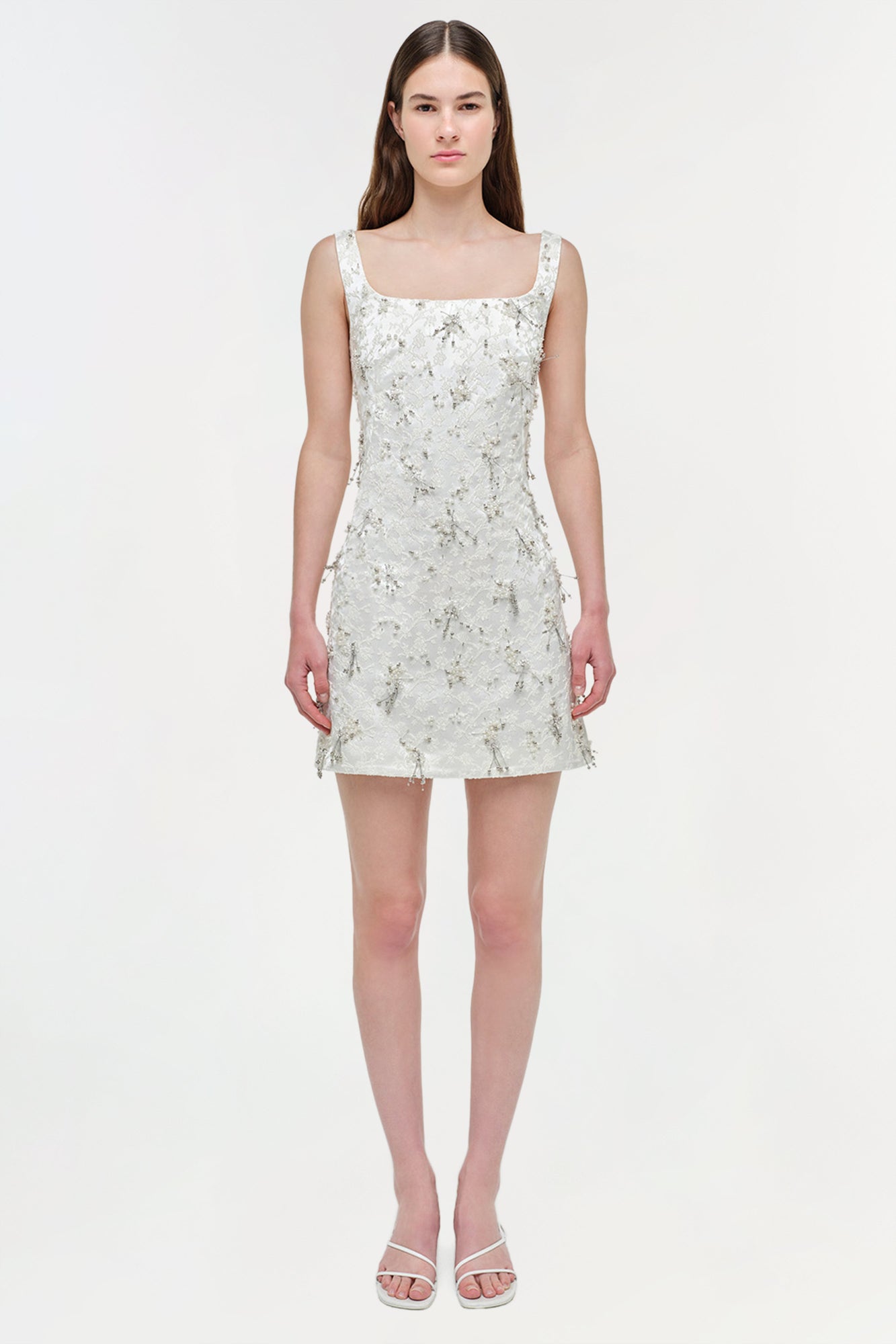White sleeveless mini dress with silver beaded embellishment throughout, square neckline, and A-line silhouette.
