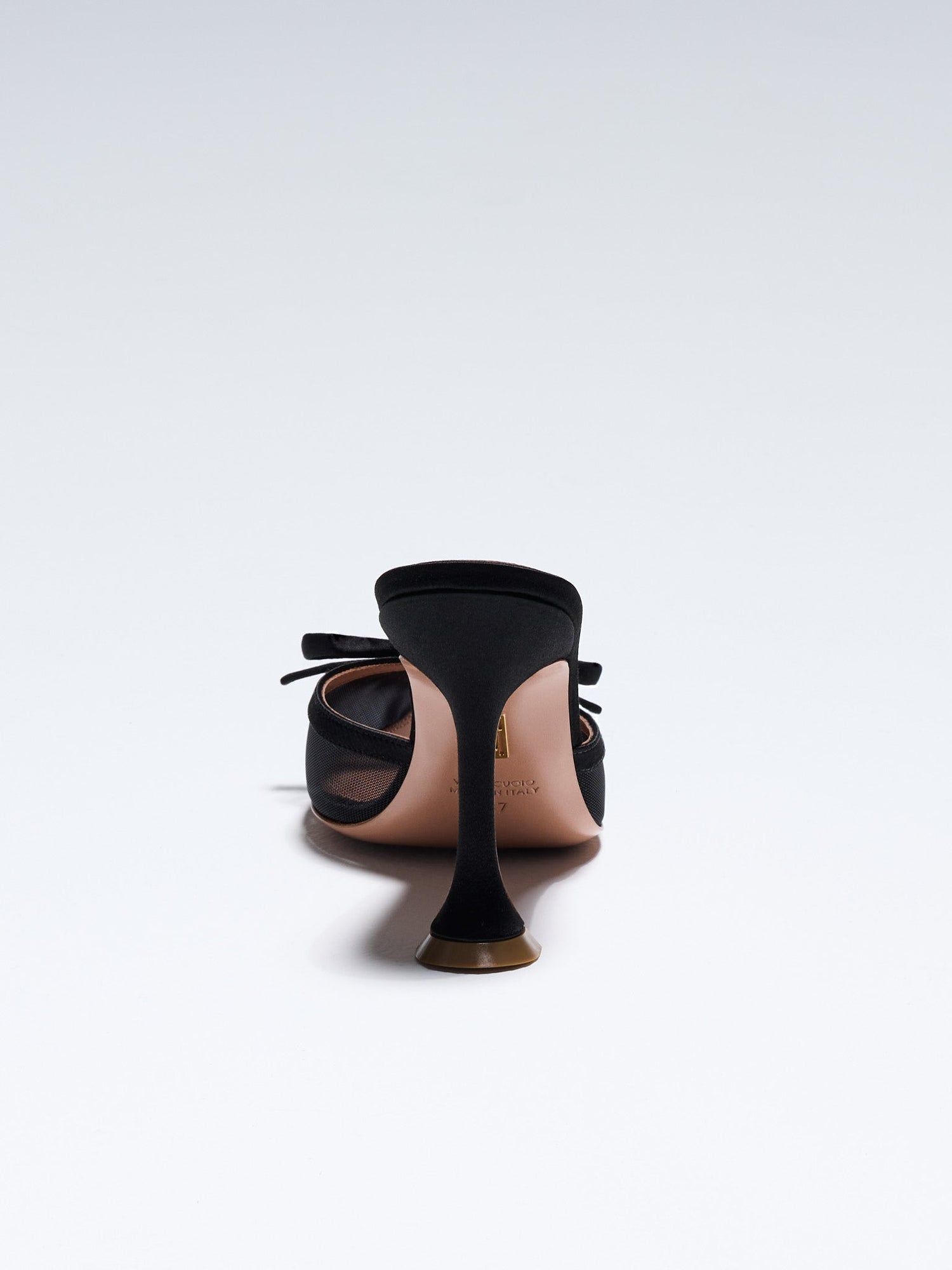 Hand-crafted in Italy, the Amelia ("Amelia") mule features a glossy black satin and is set upon our custom 95mm heel designed for your comfort. Amelia is accented with our signature mesh upper that gently molds to your foot and features an elegant satin bow making it the perfect addition to your wardrobe this holiday season.