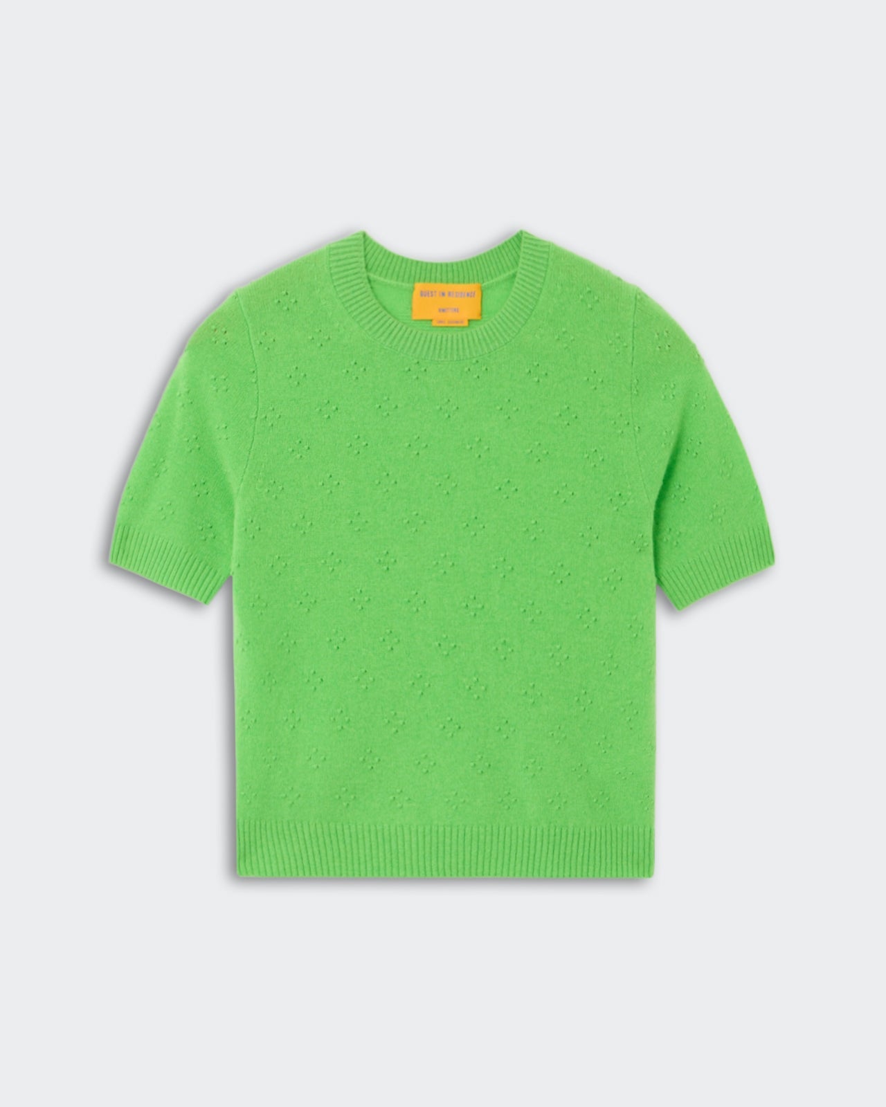 Compass Sweater Tee - Match Point, a short-sleeve knit sweater in vibrant green with a subtle textured floral pattern, featuring a crew neckline and ribbed cuffs and hem, shown flat.