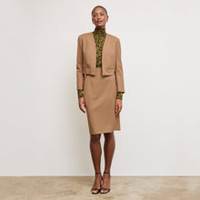 Front image of a woman standing wearing the Neale jacket in camel | Exclude