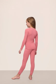 Model wearing Kids TENCEL Modal Unisex Long PJ Set in Sunkissed Coral/Ivory