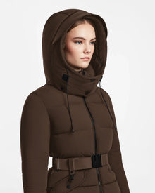 A woman models the Rudsak ADELINE - 8124544 Mocha brown quilted short down puffer jacket with a belt, standing against a white background and gazing slightly to the side, highlighting this stylish womens winter coat.