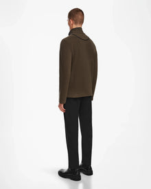 A man wearing an ARAGON - 6524539 Army sweater by Rudsak with vegan leather trims.