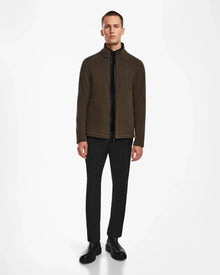 A man wears the ARAGON - 6524539 Army fleece full-zip jacket by Rudsak, featuring elegant vegan leather trims.