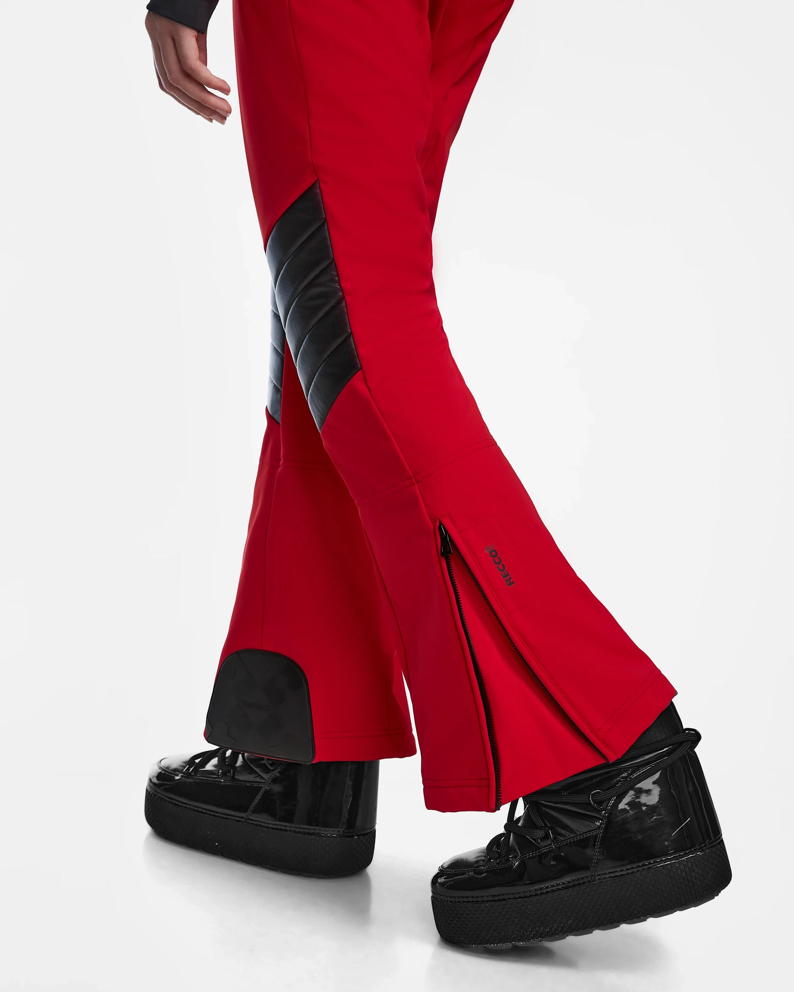 A person wears Rudsak’s ARLEY - 8124717 Flame Red pants with black quilted accents and ankle zippers, paired with black high-top sneakers, all set against a crisp white background.