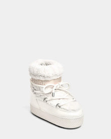 The KATHY - 8223513 Iceland by Rudsak is a white women's winter boot with faux fur lining, thick sole, faux shearling accents, lace-up front, and Rudsak logo on the cuff, shown against a plain light gray background.