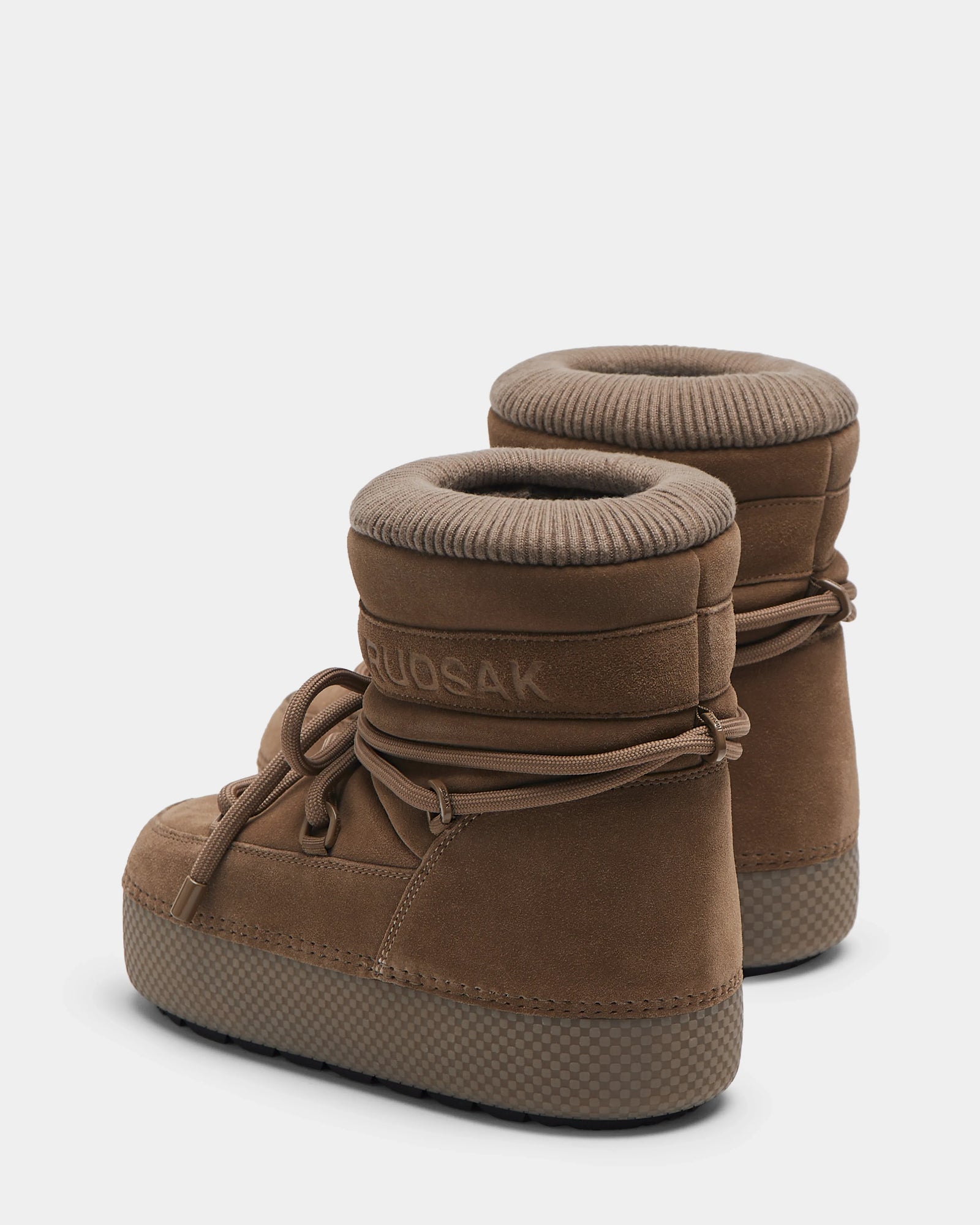 A pair of camel MACE S - 8224543 high-top winter boots by Rudsak with thick soles, corded laces, padded ankle collars, and faux fur lining for warmth. These water-repellent boots are shown against a plain white background.
