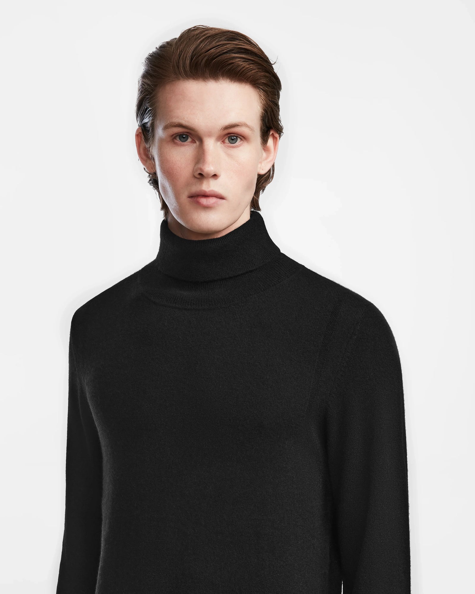 A young person with fair skin and short brown hair wears the Rudsak NICOLAS - 6524528 Black turtleneck, standing against a plain white background and looking directly at the camera with a neutral expression.