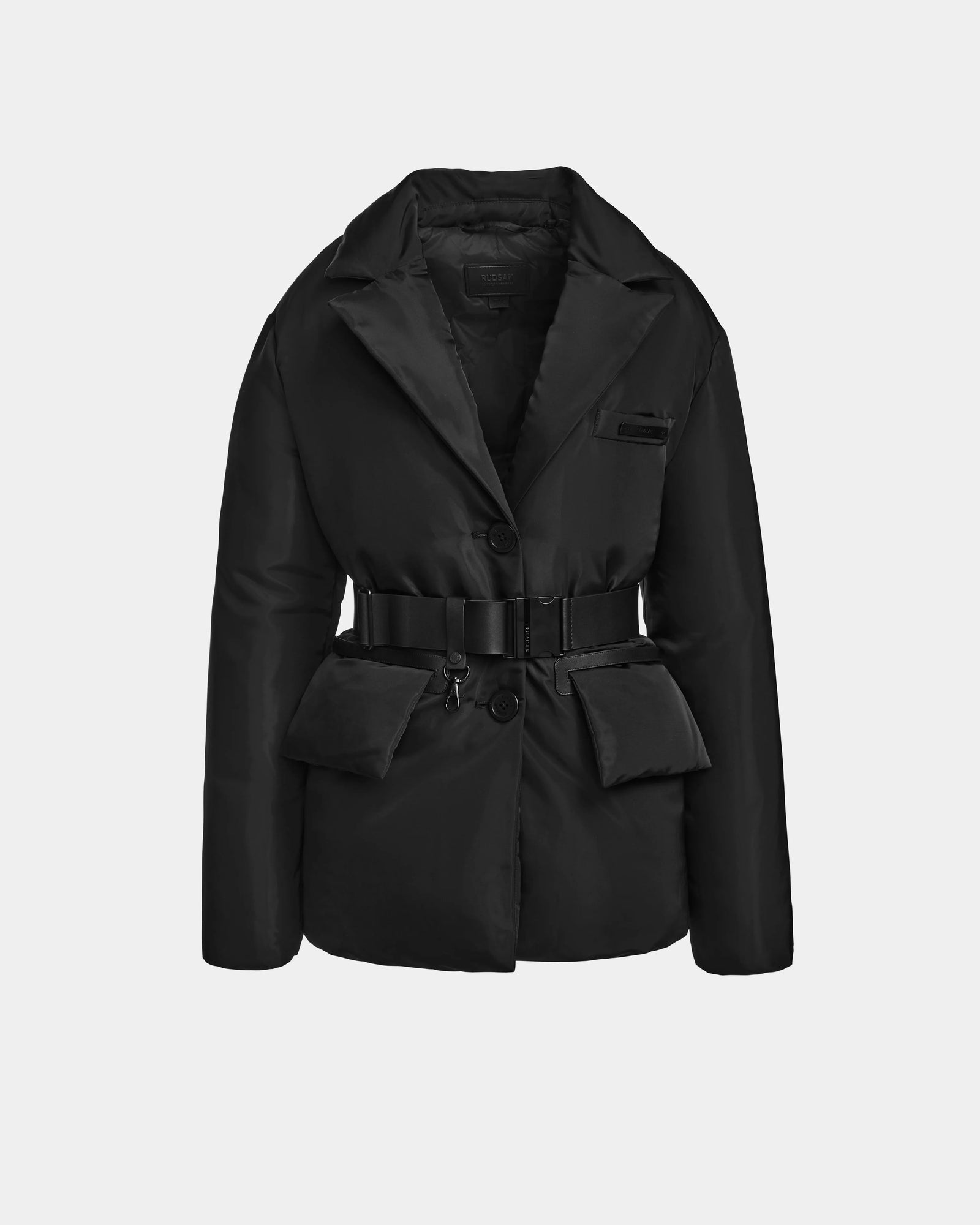 The Rudsak PAOLA - 8124547 Black is a womens down blazer jacket with padding, a notched collar, front button closure, belted waist, and flap pockets. Weather-resistant and styled in black, its shown on a white background.