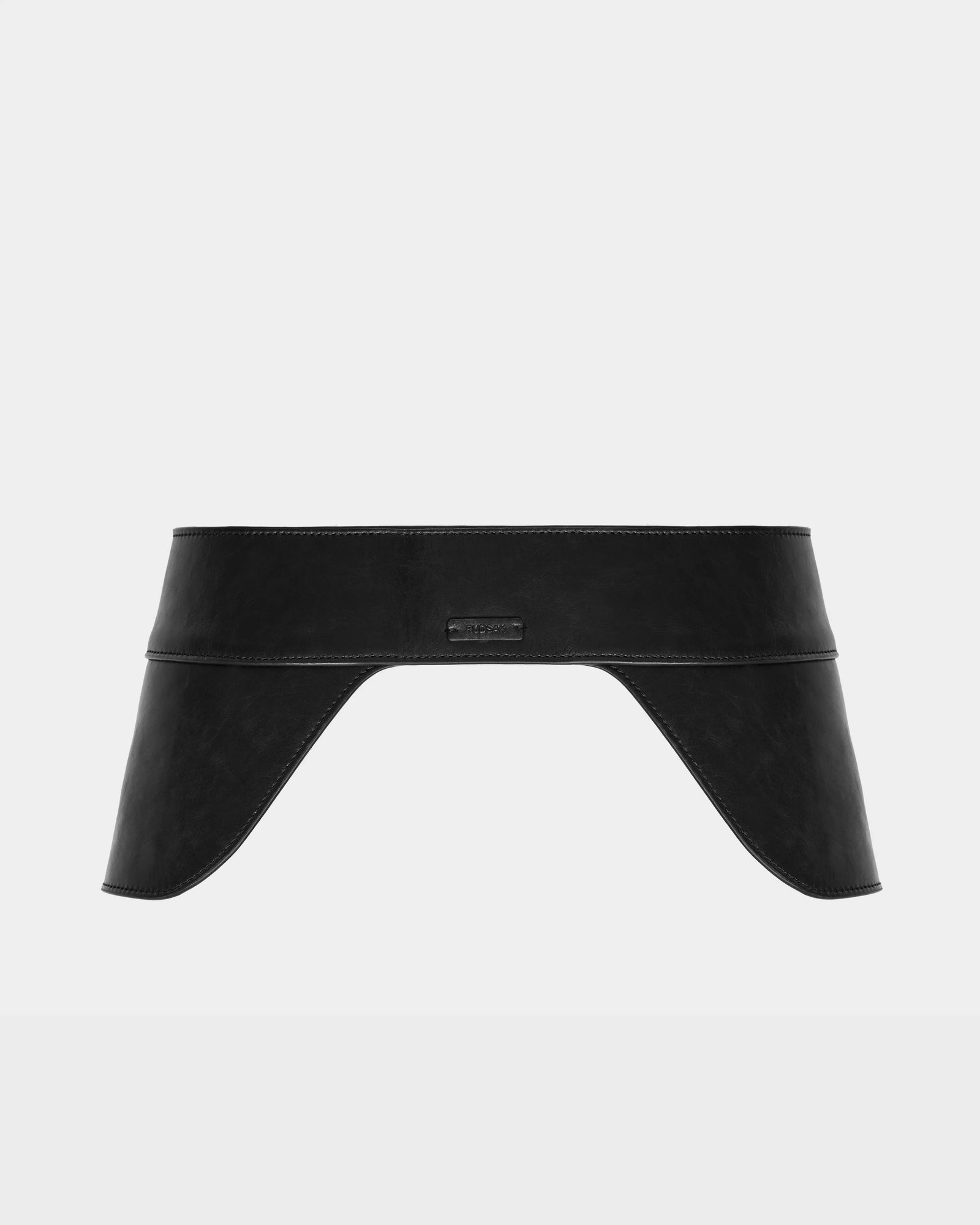 The SIMONA - 8424522 Black by Rudsak is a womens leather waist belt with wide, curved saddle side panels and a small embossed logo at the center front, shown on a plain white background.