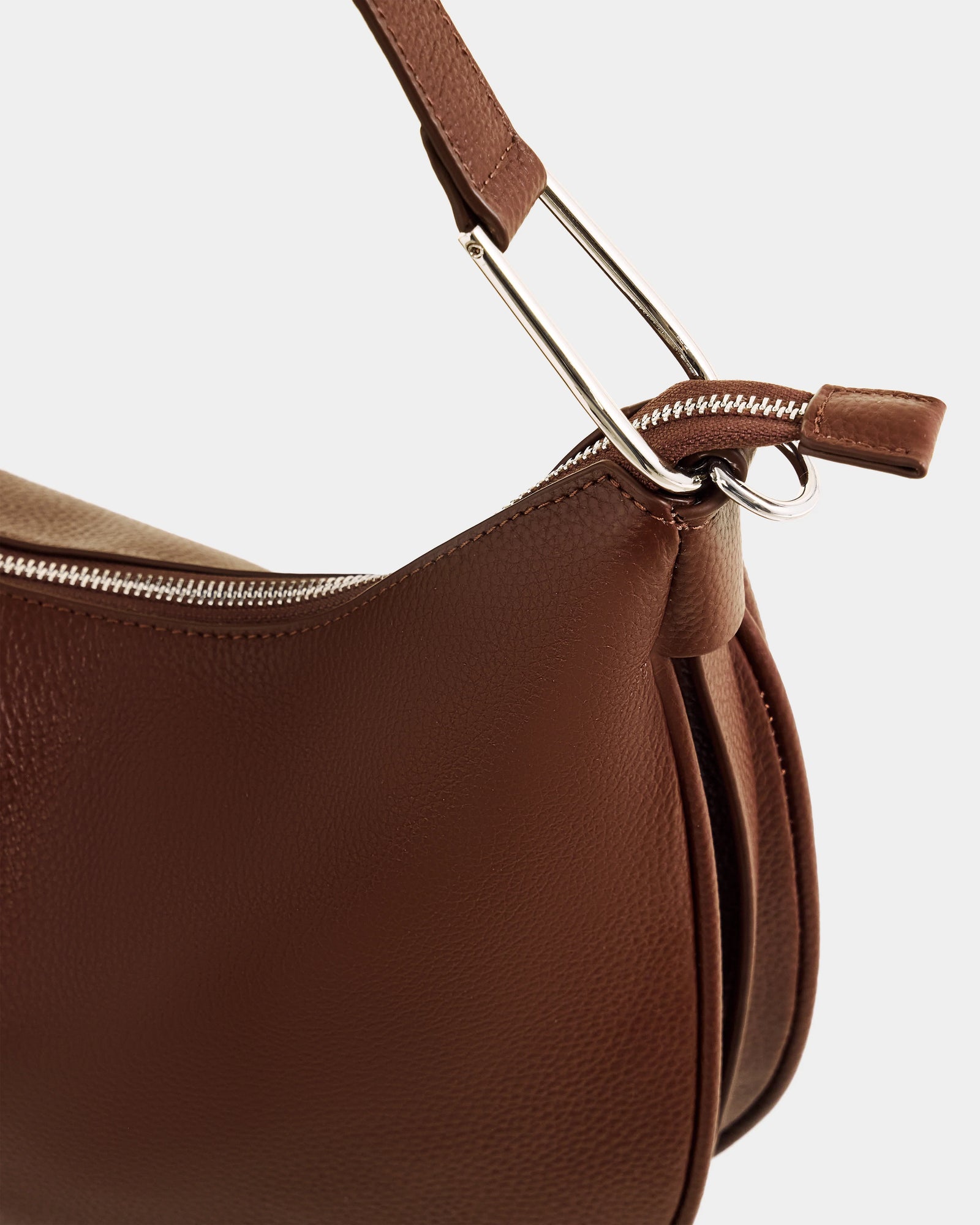 Close-up of the Rudsak SYLVIA - L325515 Mocha women's leather shoulder bag, featuring a crescent silhouette, silver zipper, metal handle attachments, and showcasing its fine texture and stitching details.