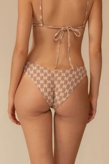 Beige lace bikini bottom with zig-zag stitch pattern and tie closure at back.