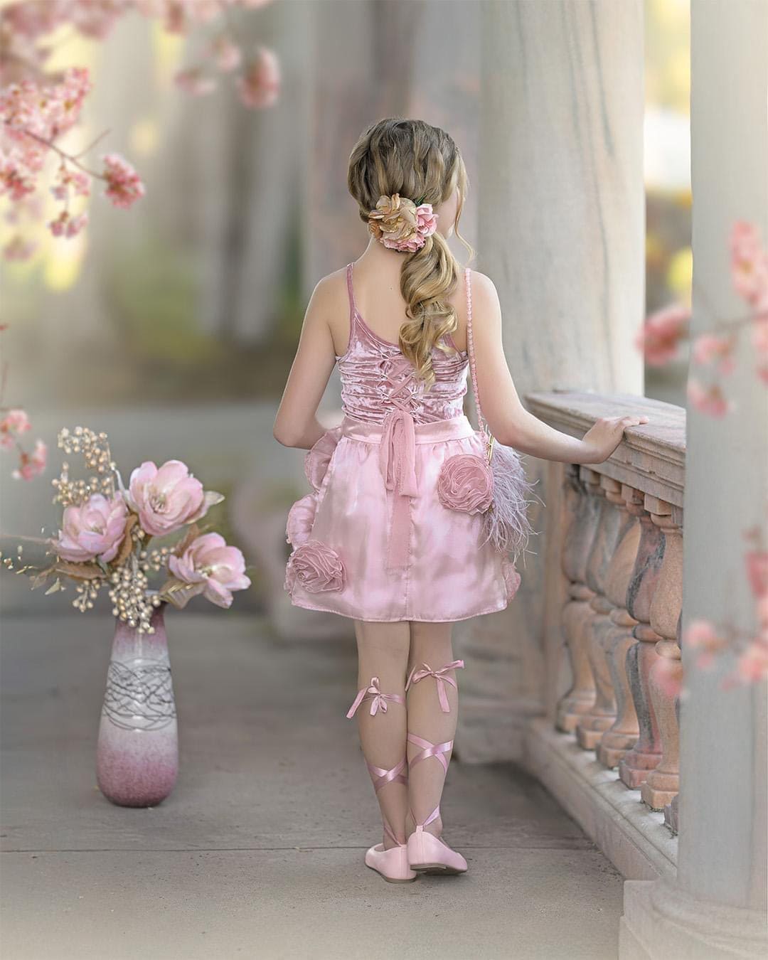 Back view of blush pink girls velvet dress with lace up back and satin bow