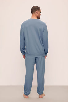 Model is wearing Mens French Terry Sweatshirt in Faded Denim