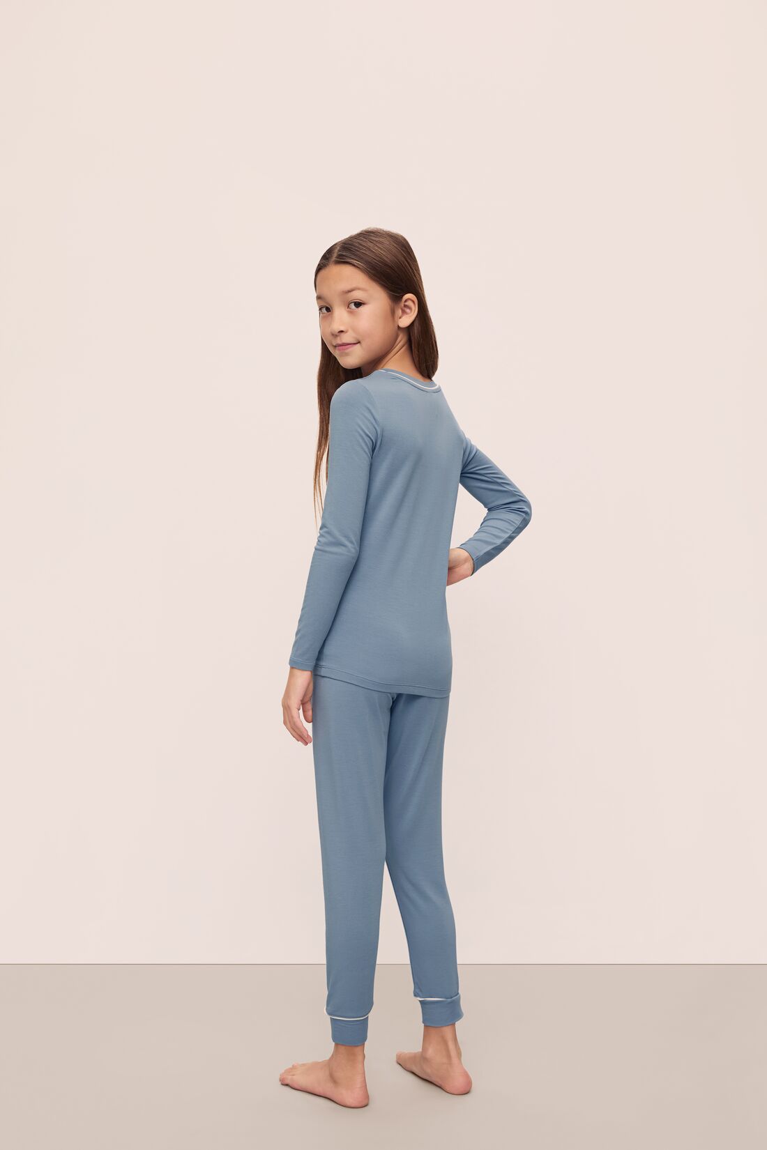 Model is wearing Kids TENCEL Modal Unisex Long PJ Set in Faded Denim/Ivory