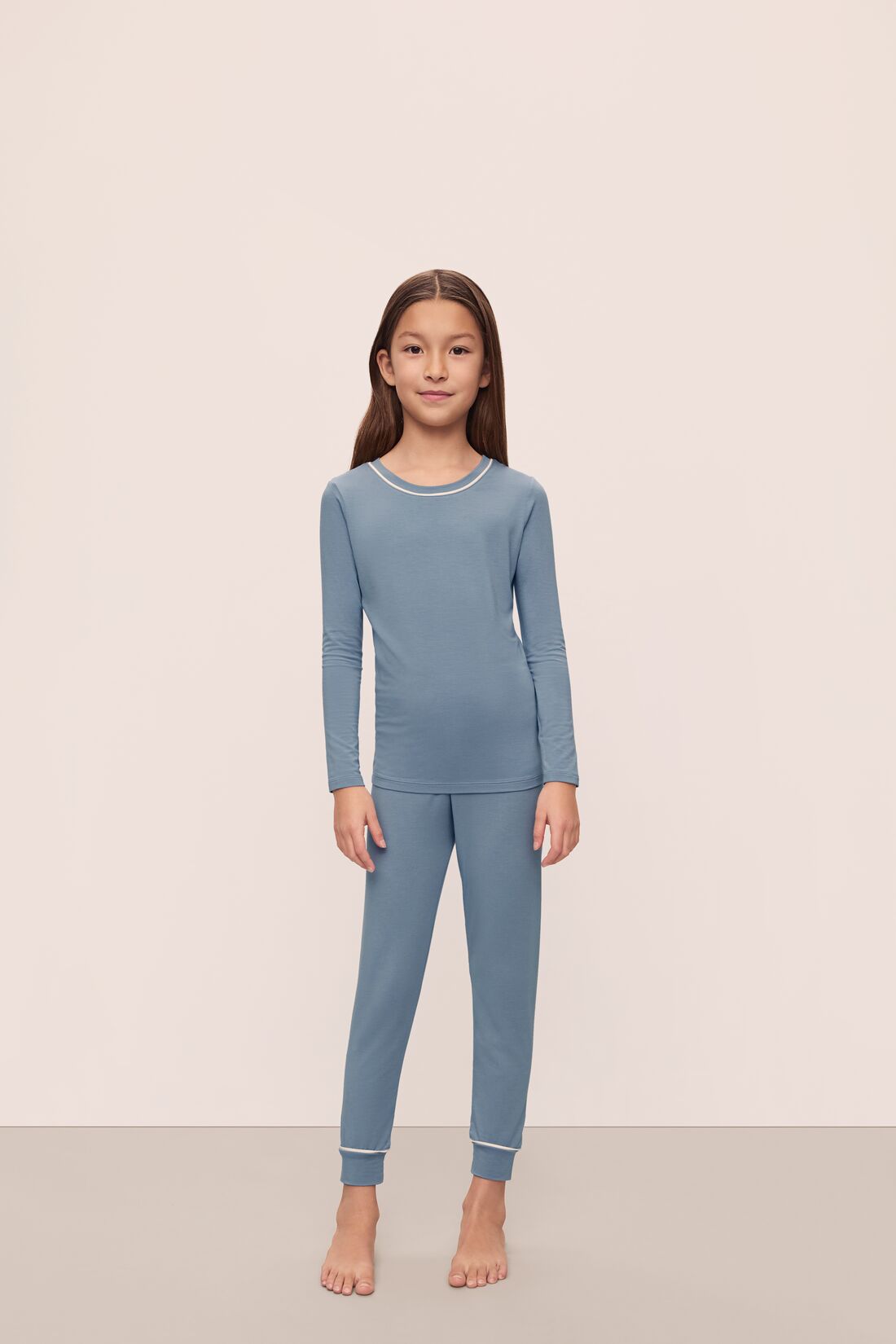 Model is wearing Kids TENCEL Modal Unisex Long PJ Set in Faded Denim/Ivory
