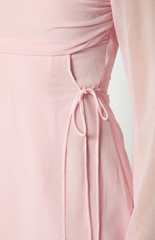 Close-up of the side drawstring ties and cutout detail on a baby pink mini dress