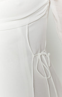 Side view showing the adjustable drawstring detail and ruched fabric of the white mini dress