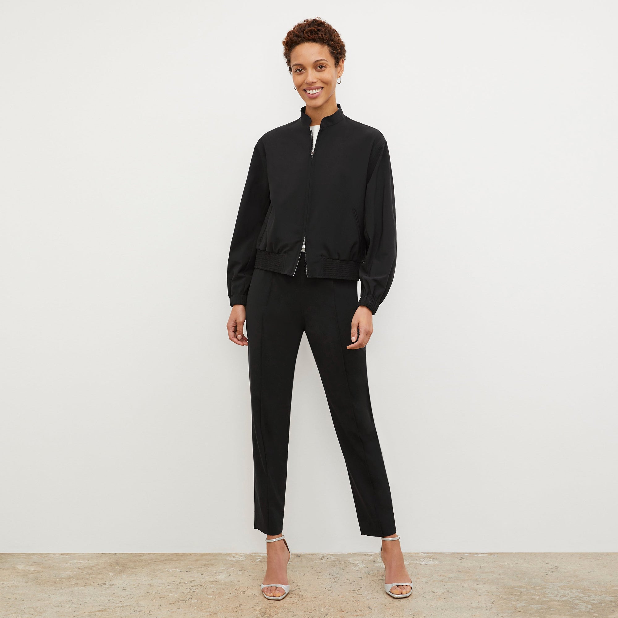 Front image of a woman standing wearing the Colby Jogger in Black | Exclude