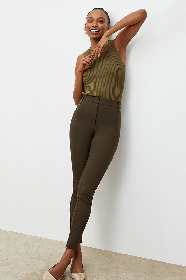 Front image of a woman standing wearing the curie pant in dark olive | Exclude