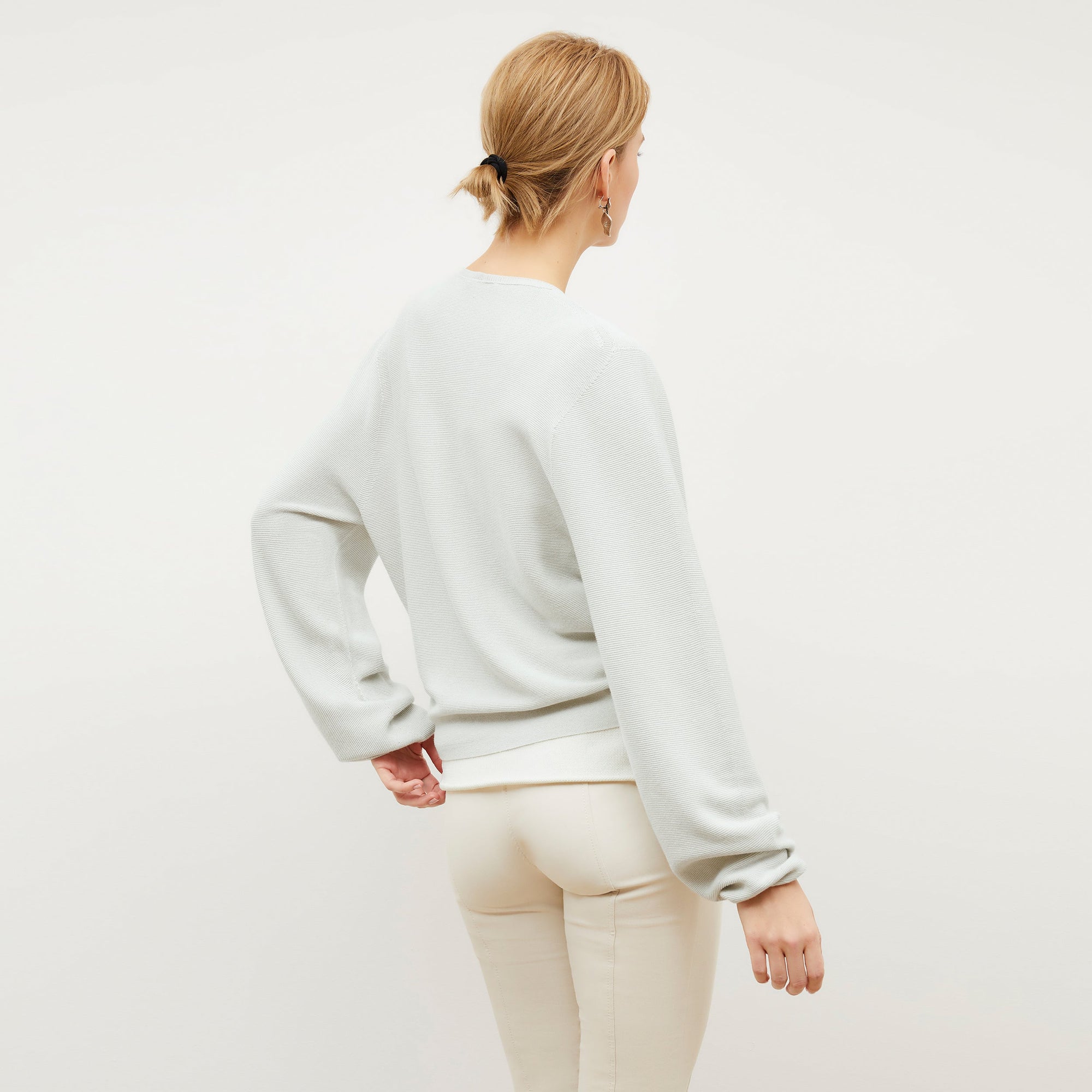 Front image of a woman standing wearing the Curie Pant—Everstretch in Bone | Exclude