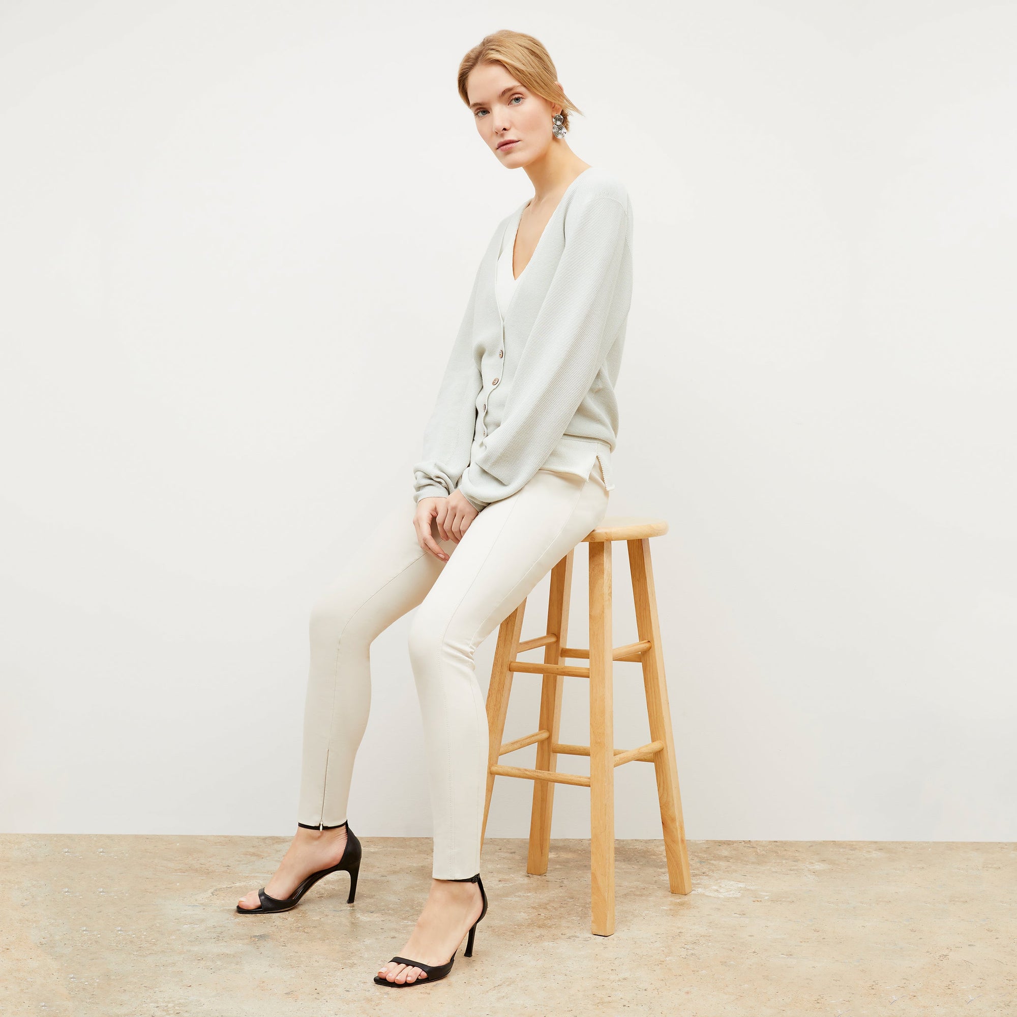 Front image of a woman standing wearing the Curie Pant—Everstretch in Bone | Exclude
