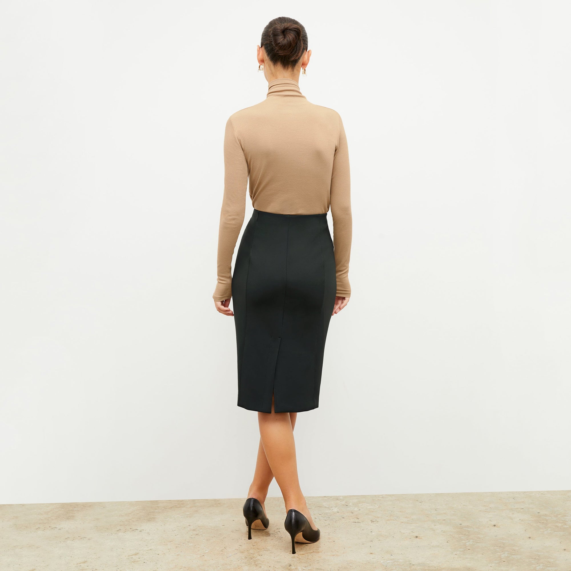 Front image of a woman standing wearing the axam top in camel | Exclude