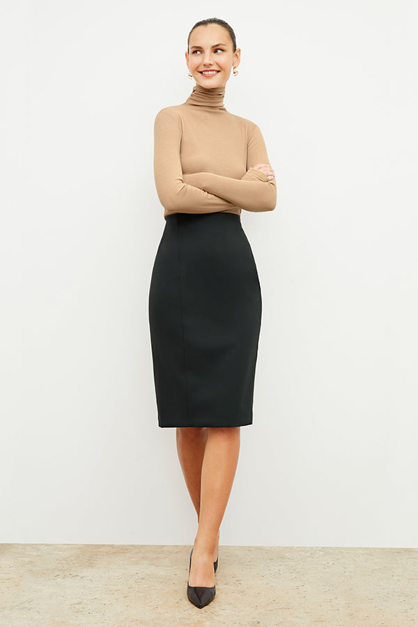 Front image of a woman standing wearing the axam top in camel | Exclude