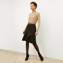 Front image of a woman standing wearing the axam top in camel | Lead