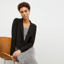 Front image of a woman wearing the Tippy Dress in Brick and Black
