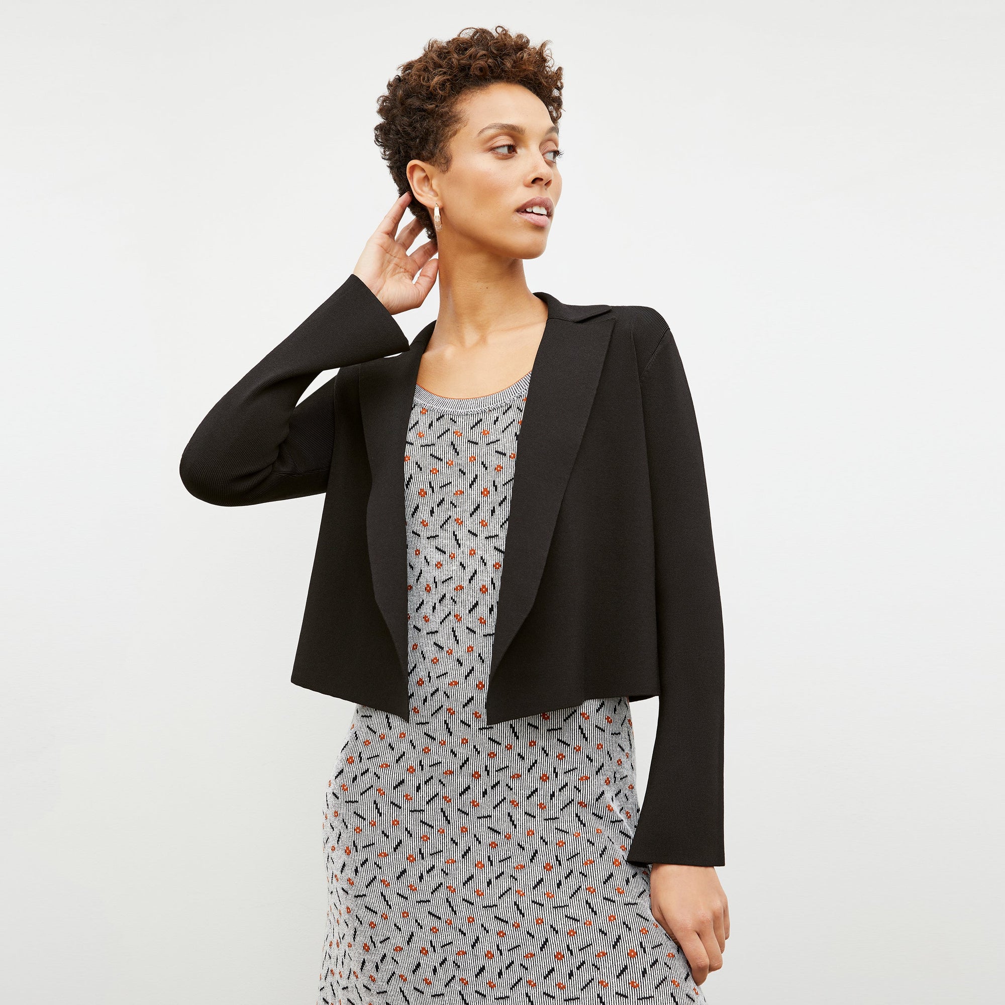 Front image of a woman wearing the Tippy Dress in Brick and Black