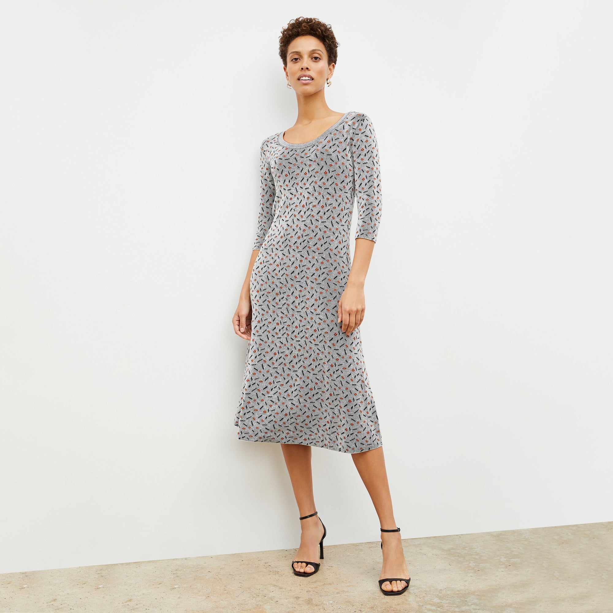 Front image of a woman wearing the Tippy Dress in Brick and Black