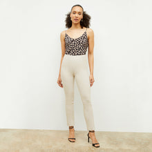 Front image of a woman standing wearing the foster pant in bone