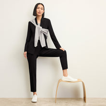 Front image of a woman standing wearing the Colby Jogger in Black | Exclude
