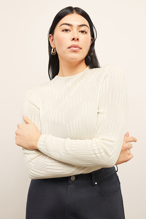 front image of a woman wearing the brodie top in ivory | Exclude 