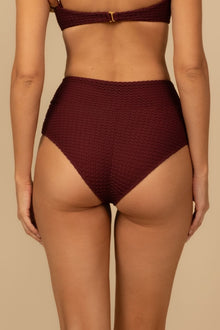 Maroon crochet high-rise bikini bottom with textured pattern and gold clasp detail at center front.