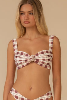 Maroon and white plaid bikini top with sweetheart neckline and center bow detail on model.