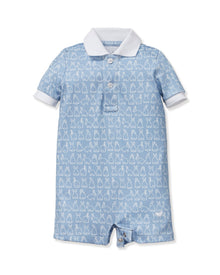 The Baby's Pima Louis Play Romper in Hoppy Days Blue is a light blue short-sleeve romper with a white collar and sleeve cuffs, a white bunny outline pattern, and bottom snaps for easy changing.