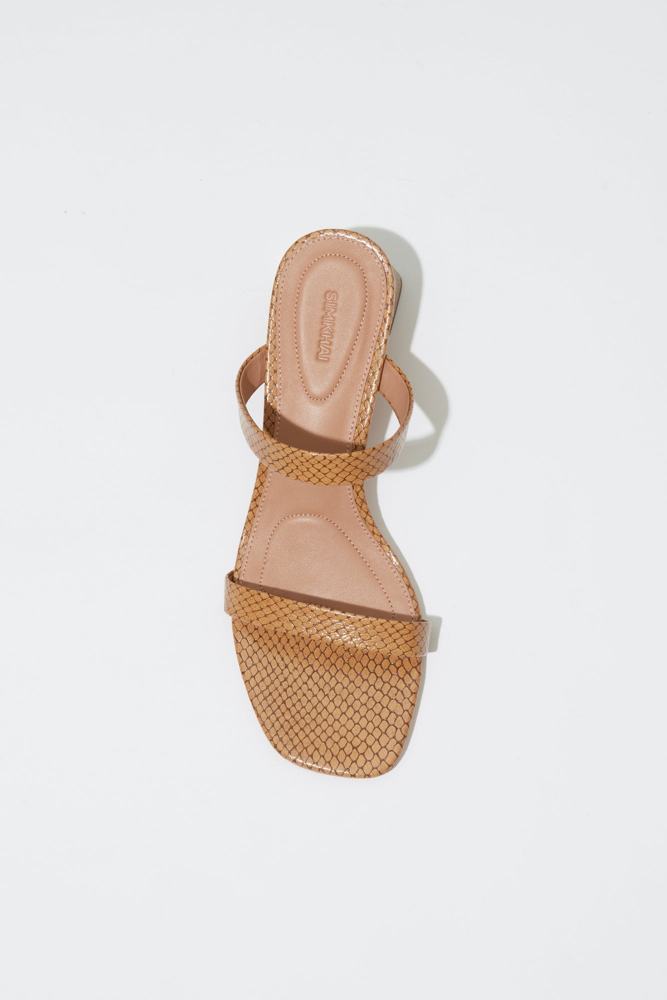 Tan leather slide sandal with debossed texture straps and block heel, shown from above.